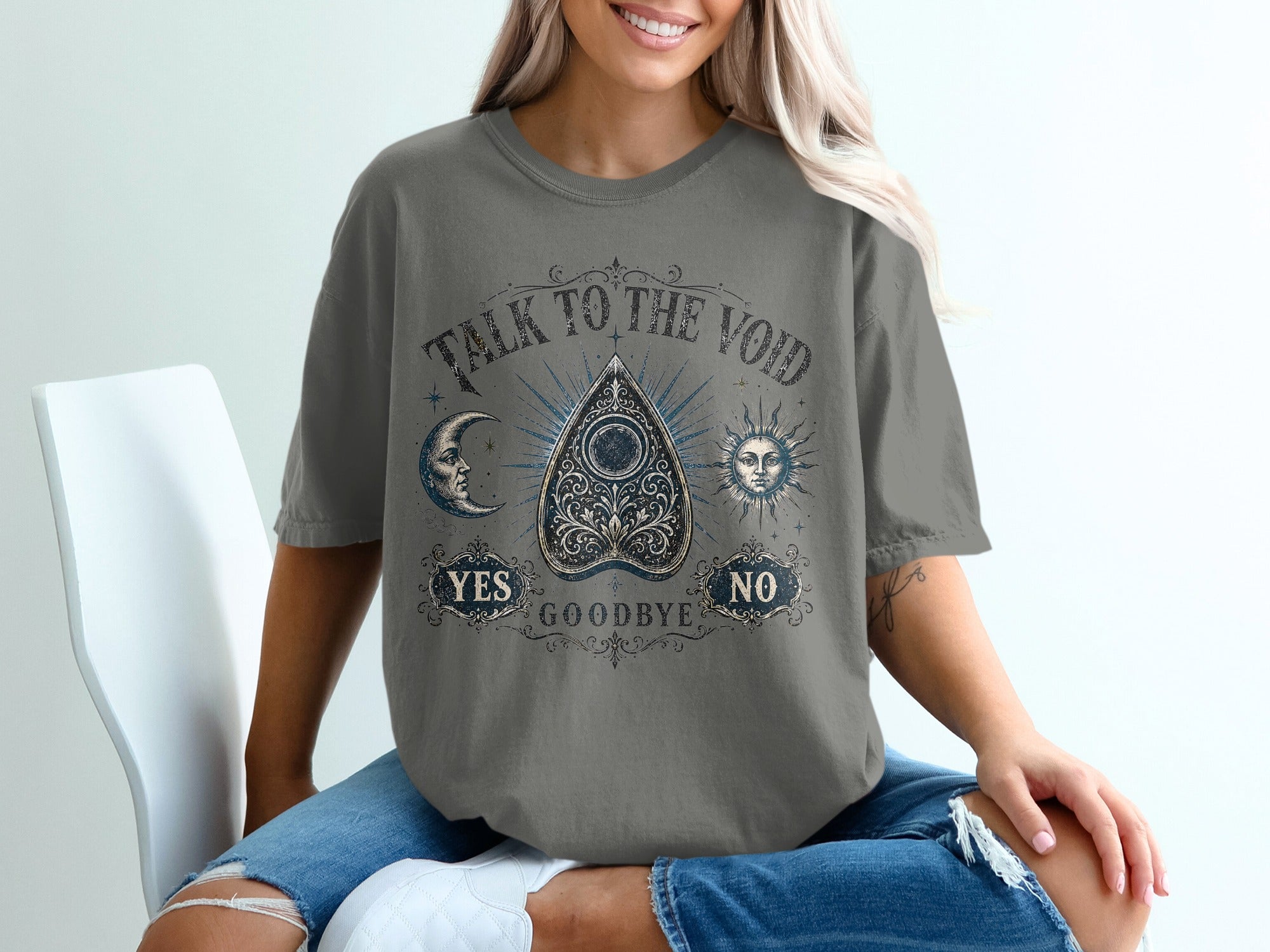 T-shirt graphic with Ouija board, moon, sun, "Talk to the Void," "Yes," "No," and "Goodbye."