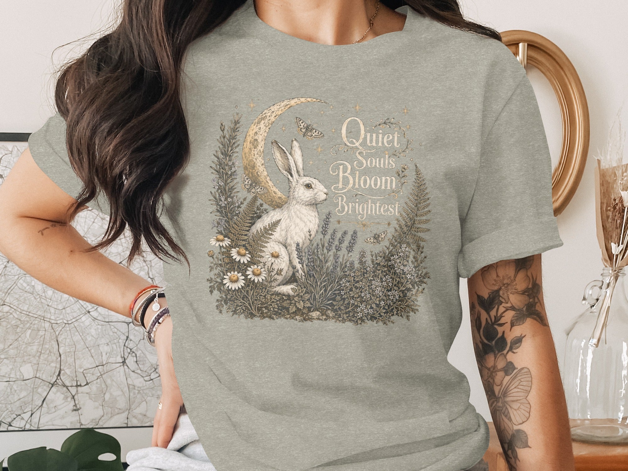 White rabbit with moon, butterflies, and text "Quiet Souls Bloom Brightest".