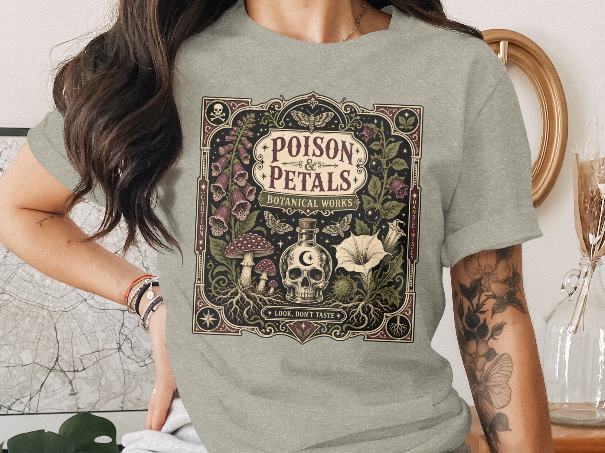 Gray t-shirt with "Poison & Petals Botanical Works" text and skull with plants.