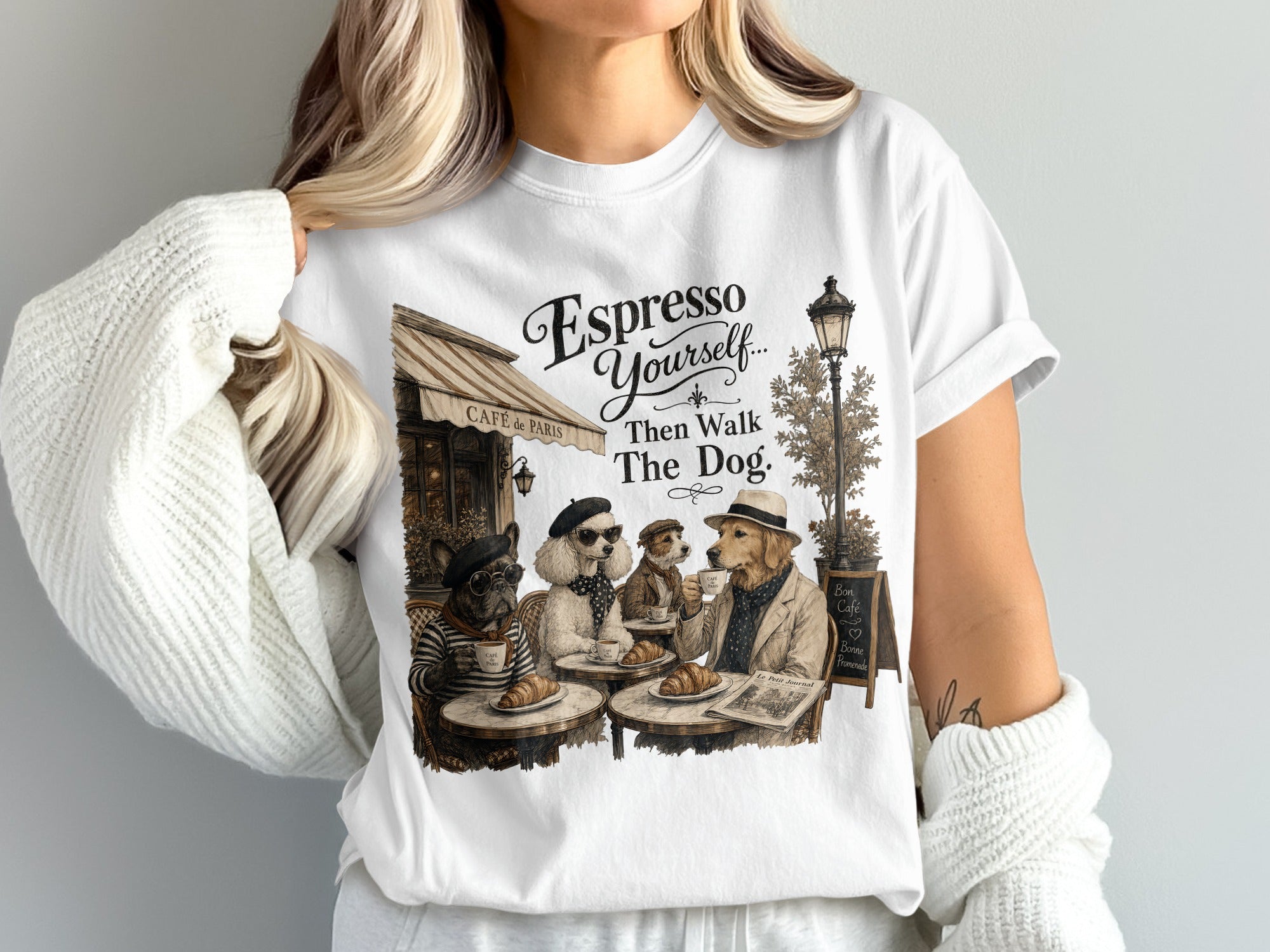Dogs in fancy attire sit at cafe tables outside "Café de Paris" with text.