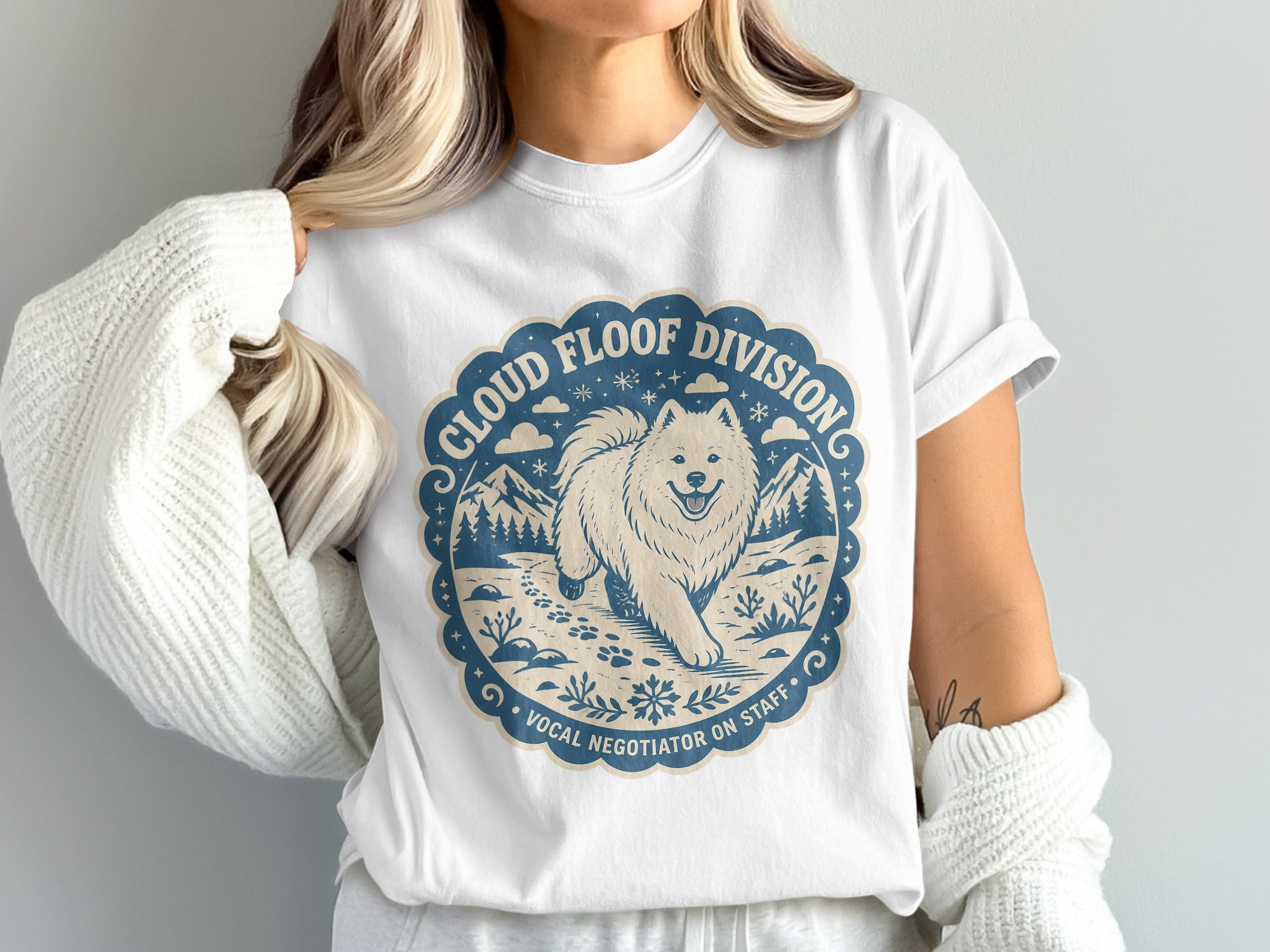 White t-shirt with a blue circular graphic of a Samoyed dog and "Cloud Floof Division Vocal Negotiator On Staff".