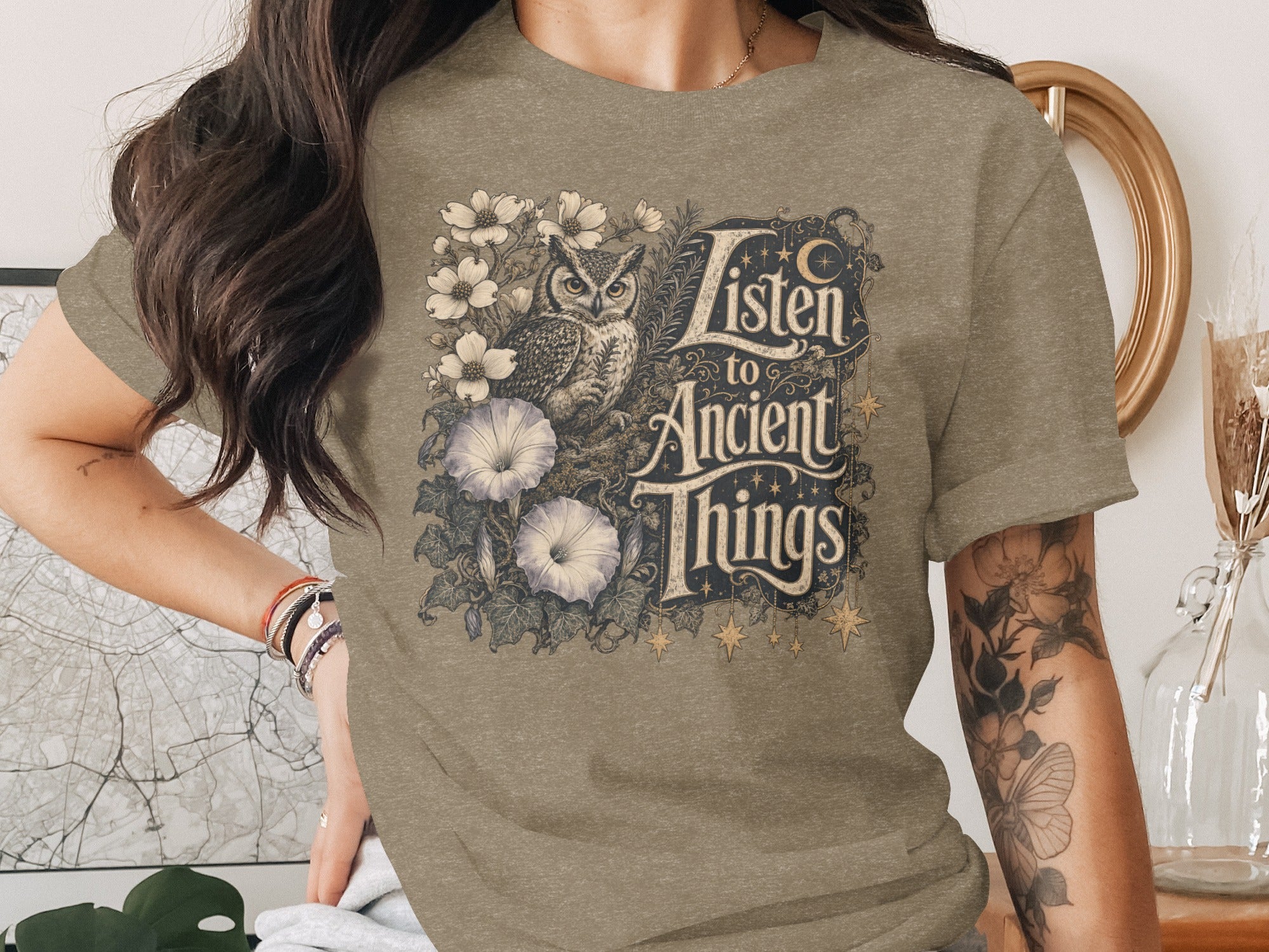 T-shirt with owl, flowers, and text "Listen to Ancient Things".