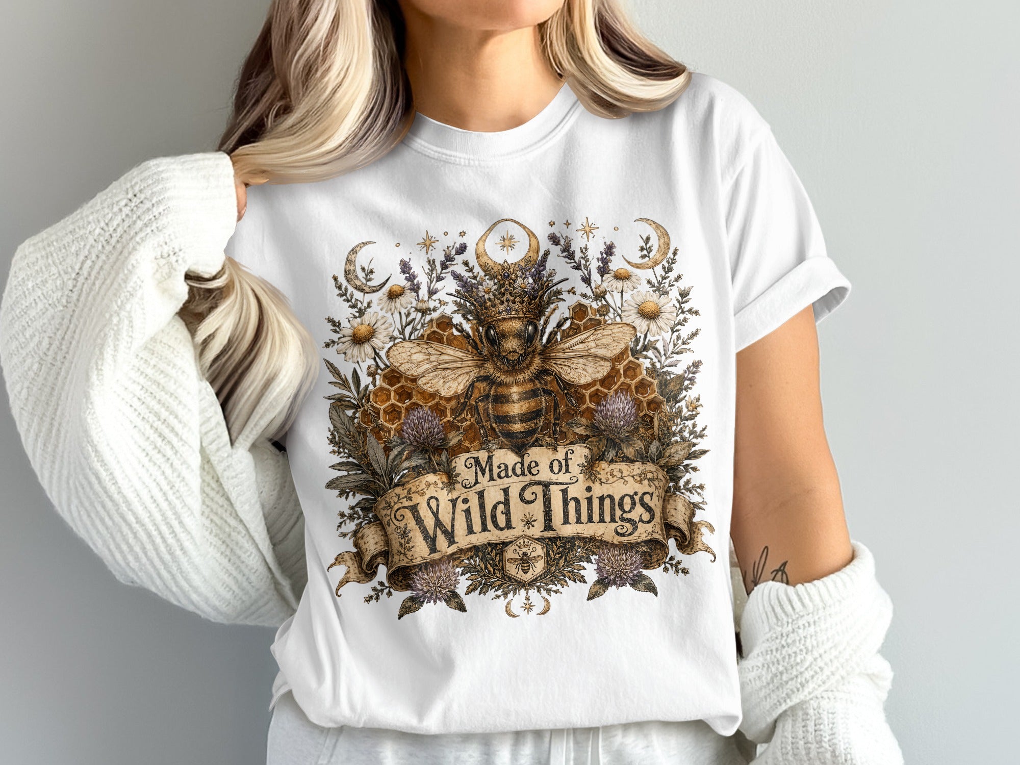 White t-shirt with a regal bee artwork and text "Made of Wild Things".