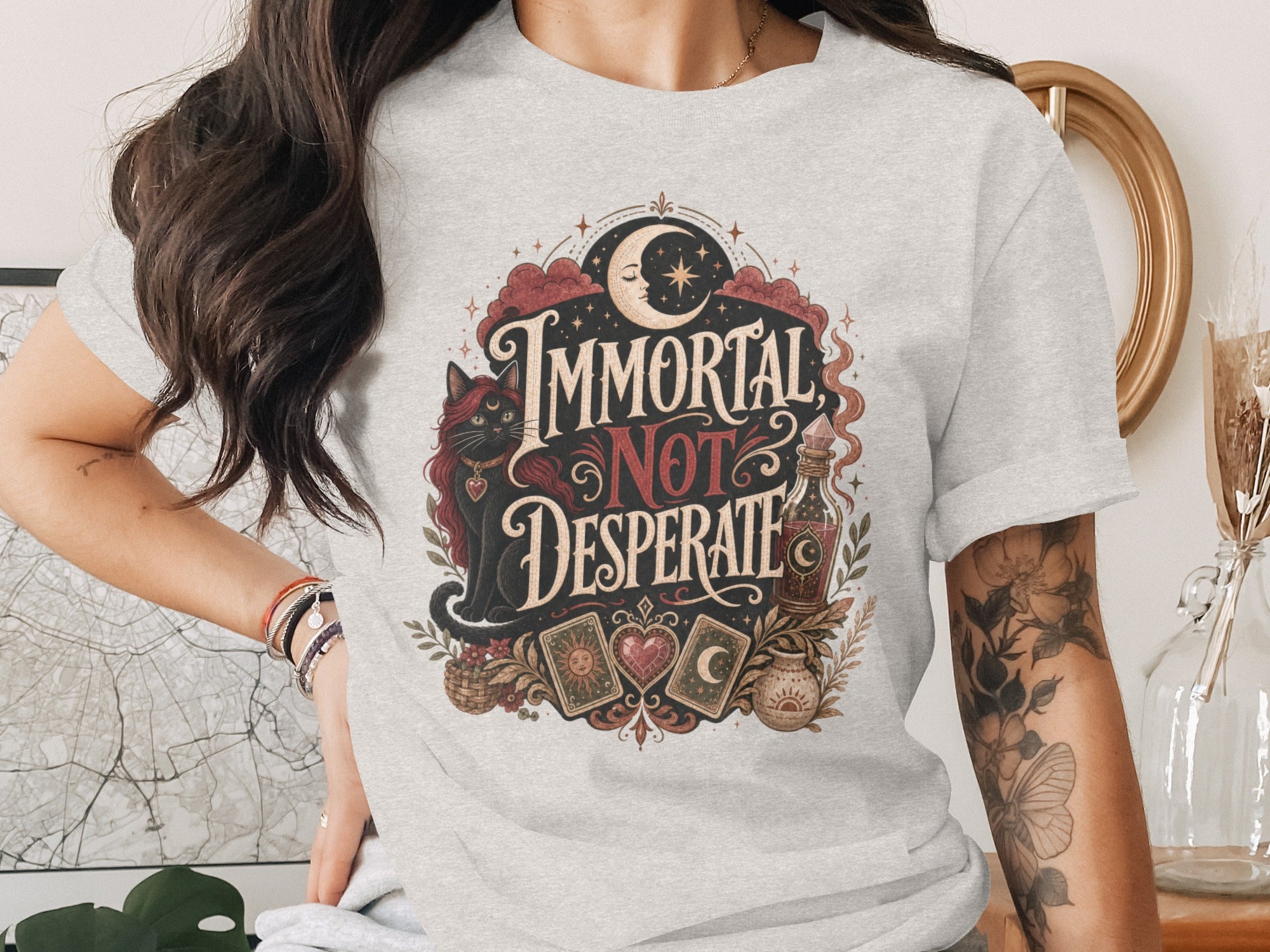 T-shirt graphic with a black cat, tarot cards, and "Immortal Not Desperate" text.