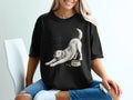 Black t-shirt with a drawing of a dog stretching next to a bowl of kibble,text "Powered By Snacks".