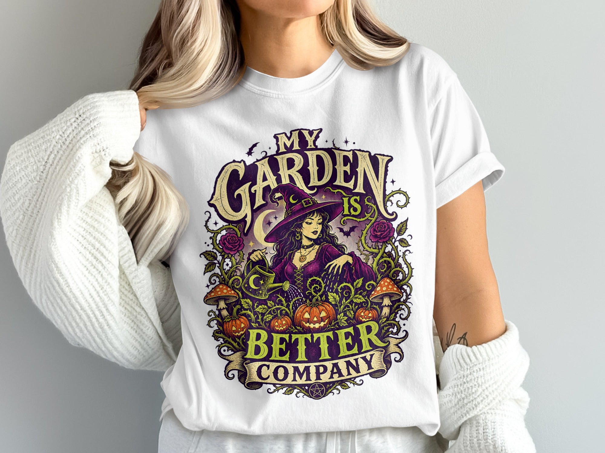 White t-shirt with graphic: Witch watering plants with text "My Garden Is Better Company"