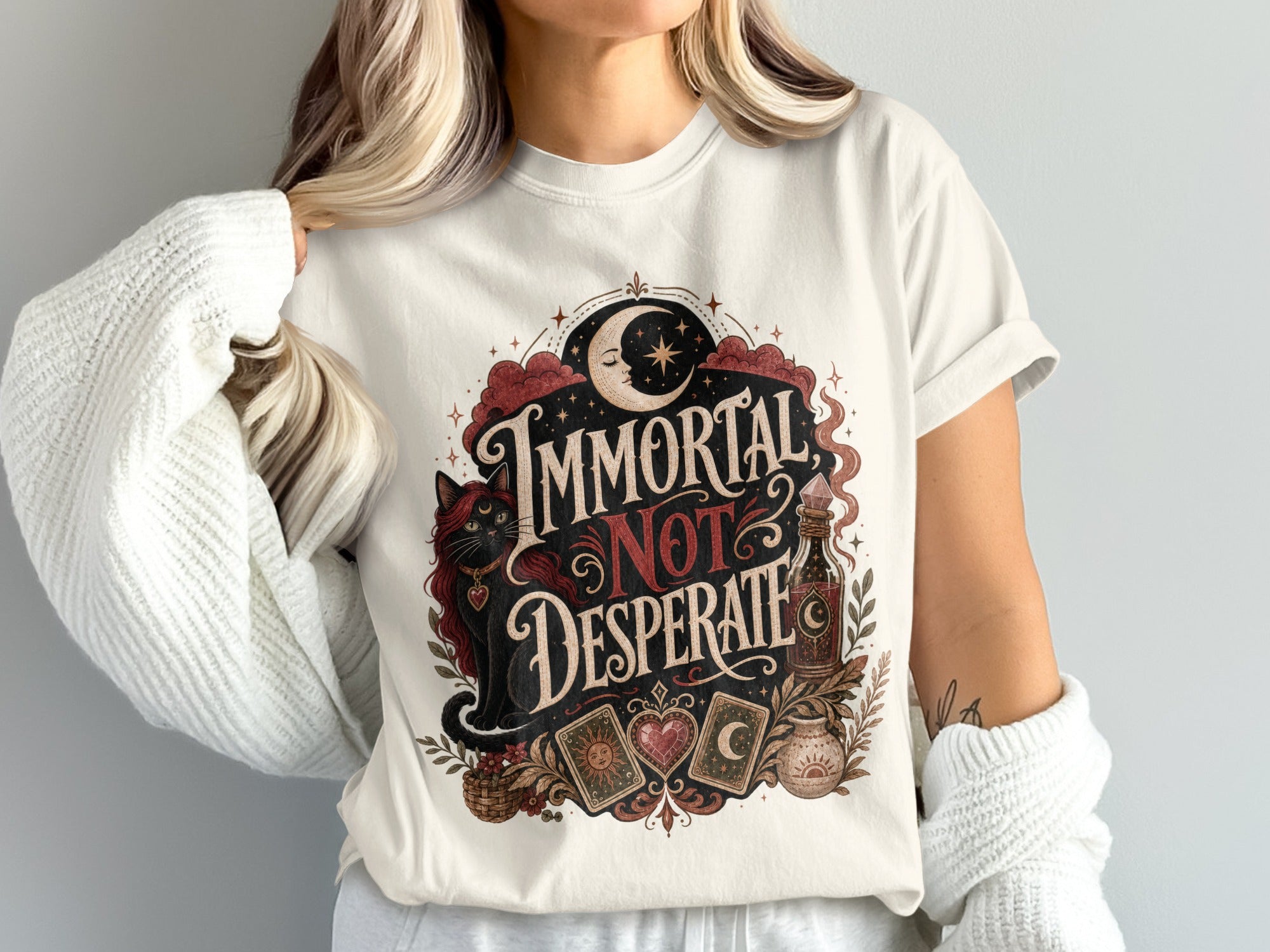Cream t-shirt with moon, black cat, tarot cards, and "Immortal Not Desperate" text.