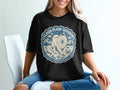 Black t-shirt with circular design: Samoyed dog, mountains, clouds, and text.