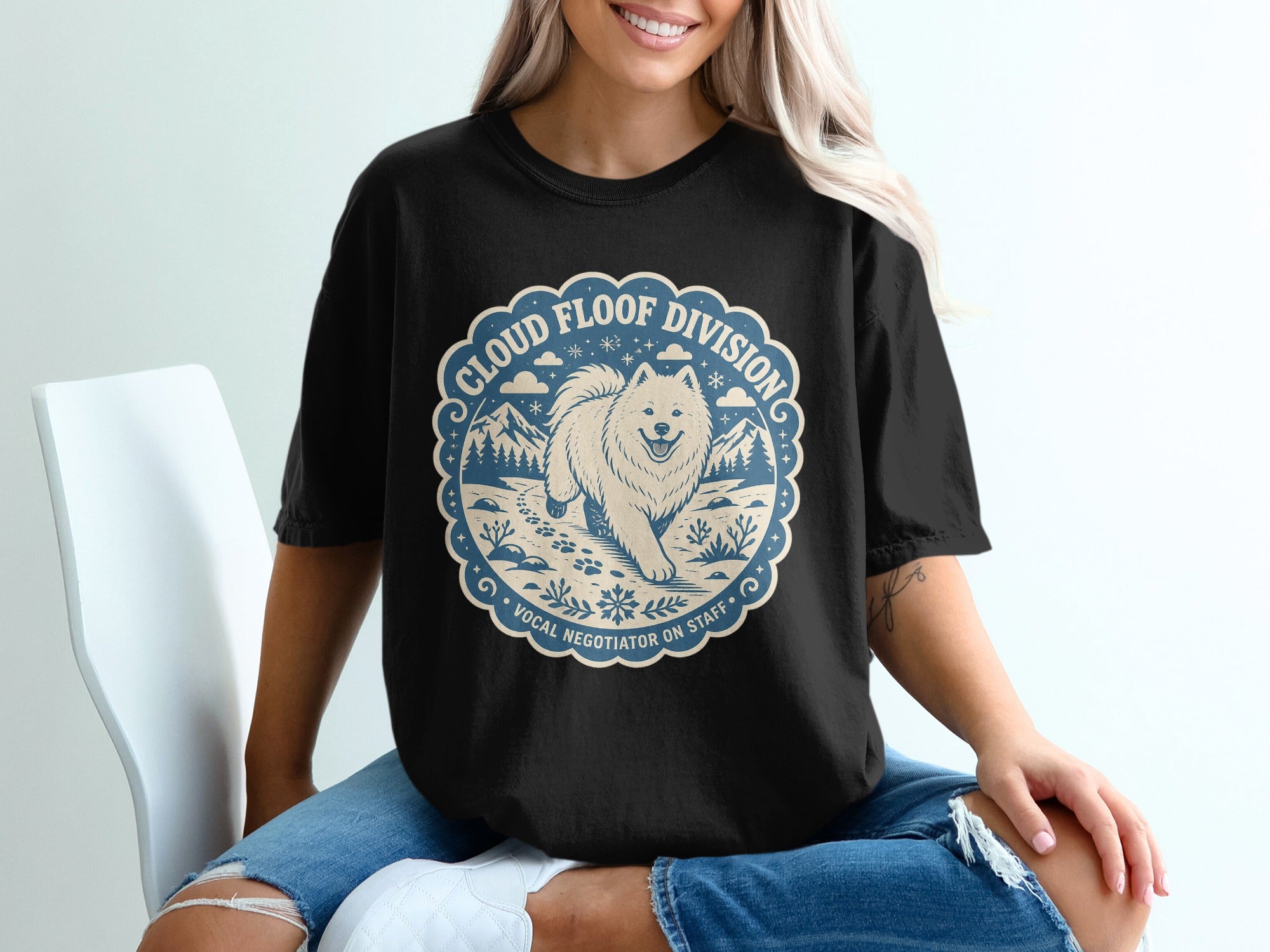 Black t-shirt with circular design: Samoyed dog, mountains, clouds, and text.