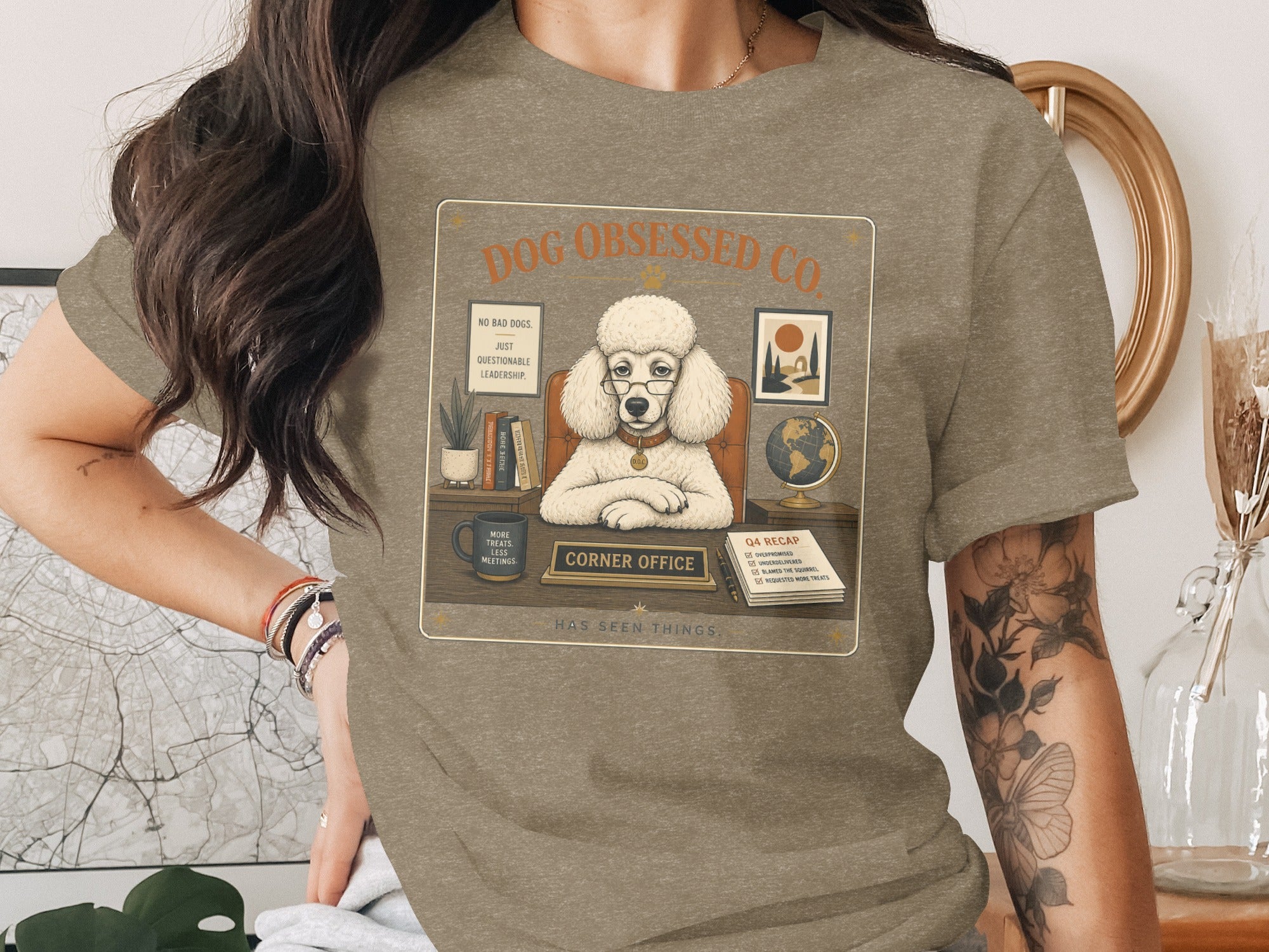 Poodle in glasses at a desk with "Corner Office" sign and "Q4 Recap" list.