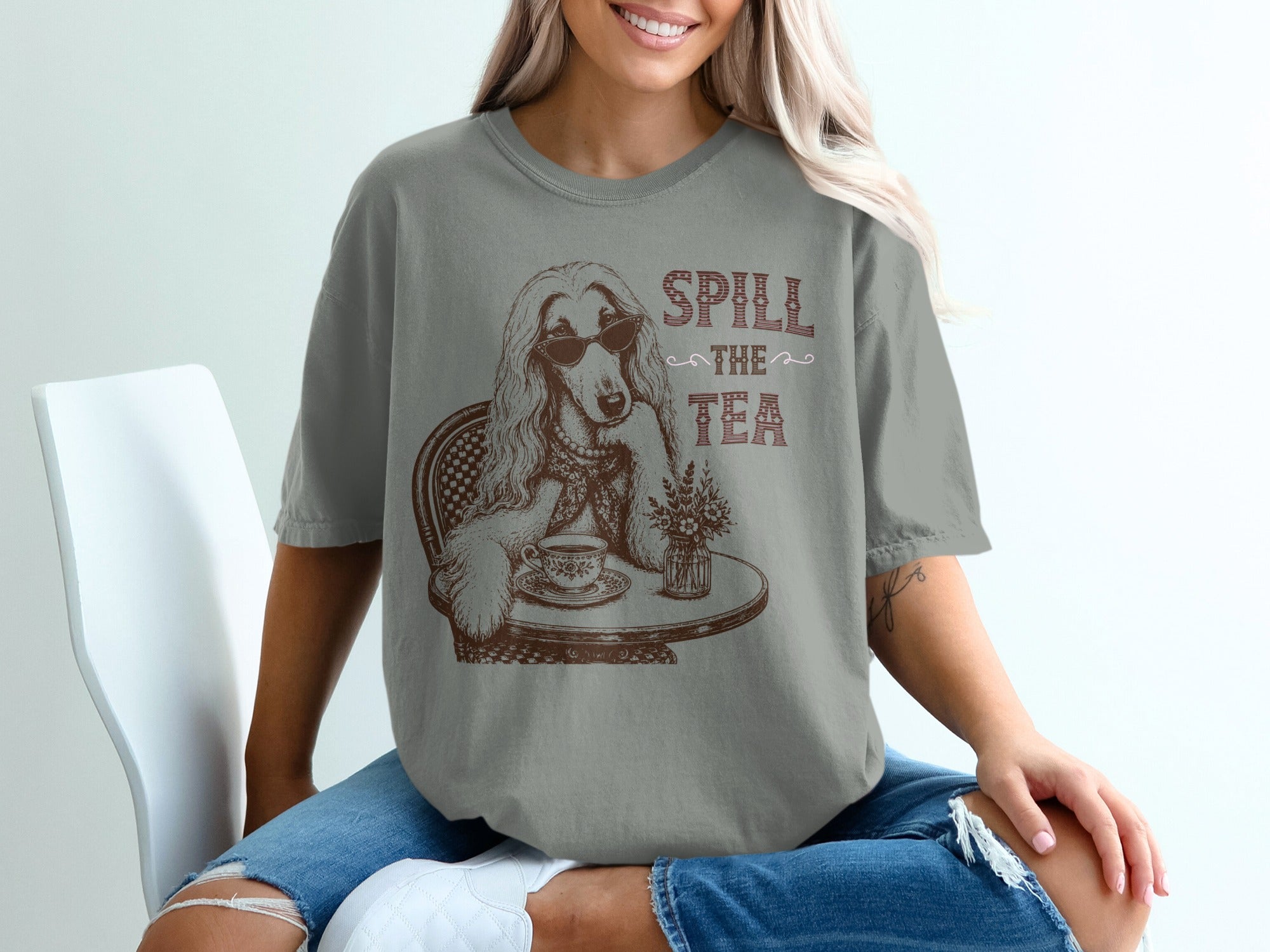 Graphic tee with a dog wearing sunglasses and text "Spill the Tea".