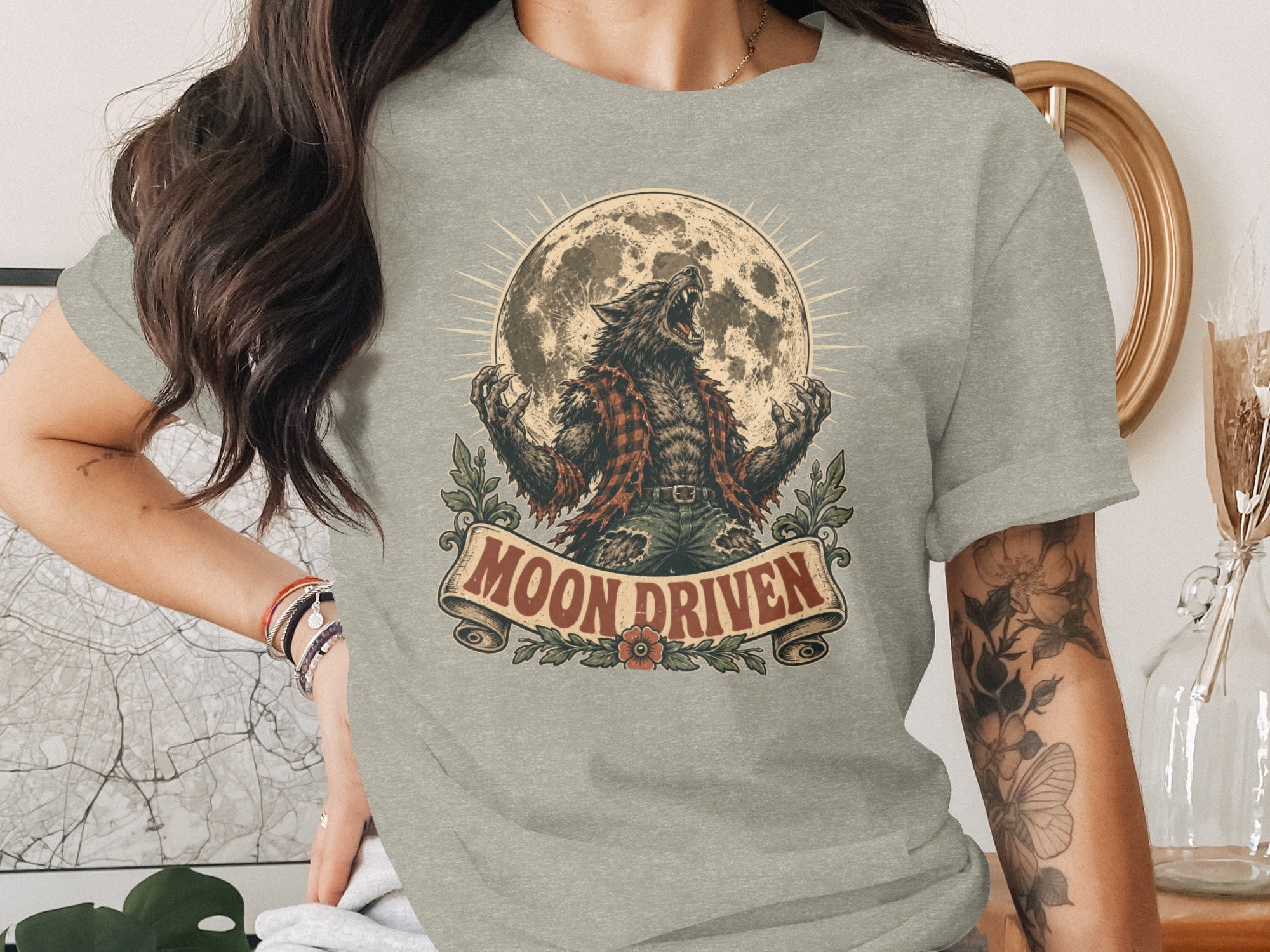 Werewolf howling at moon on t-shirt with "Moon Driven" text banner.