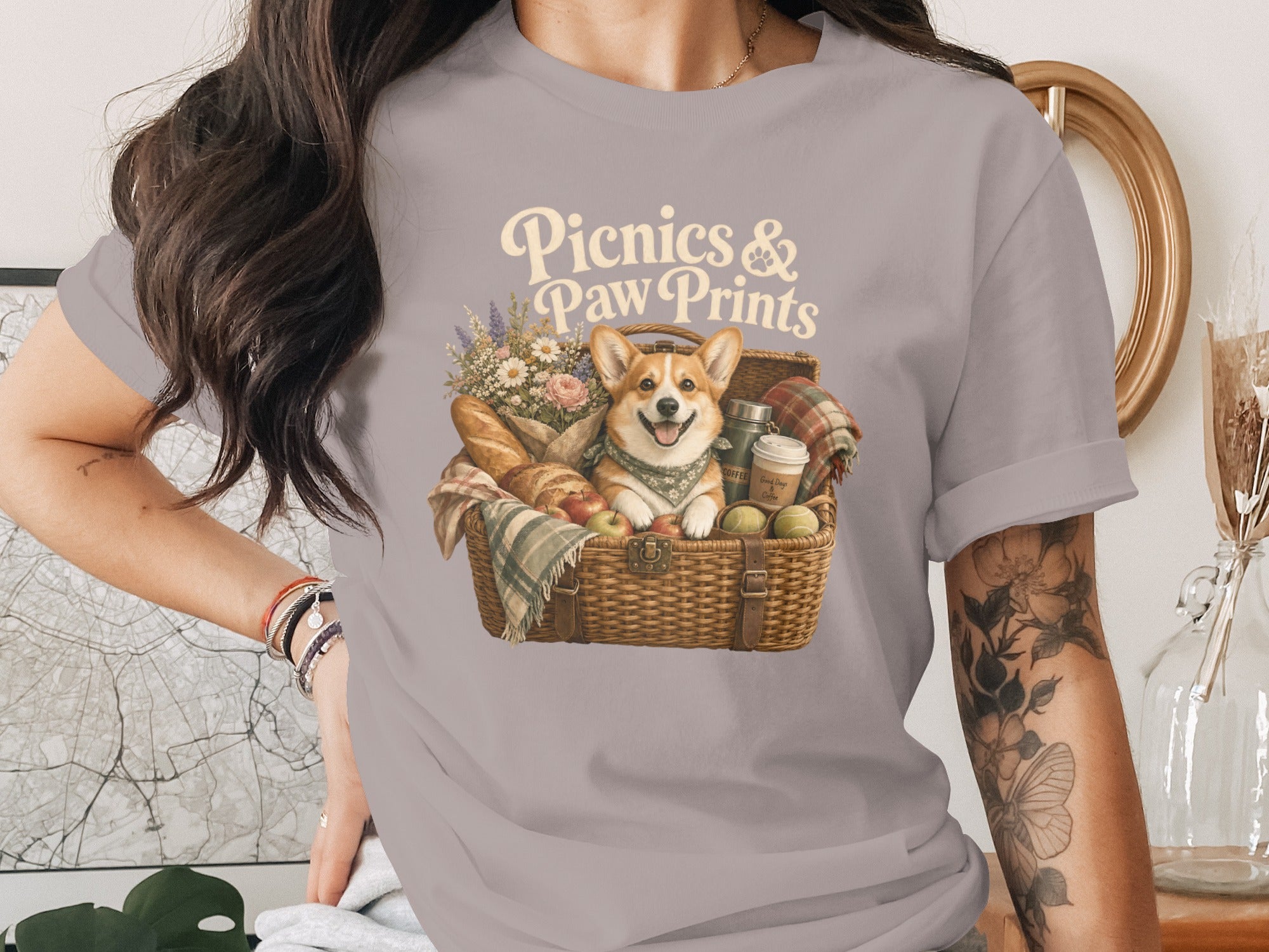 Corgi in picnic basket with text "Picnics & Paw Prints".