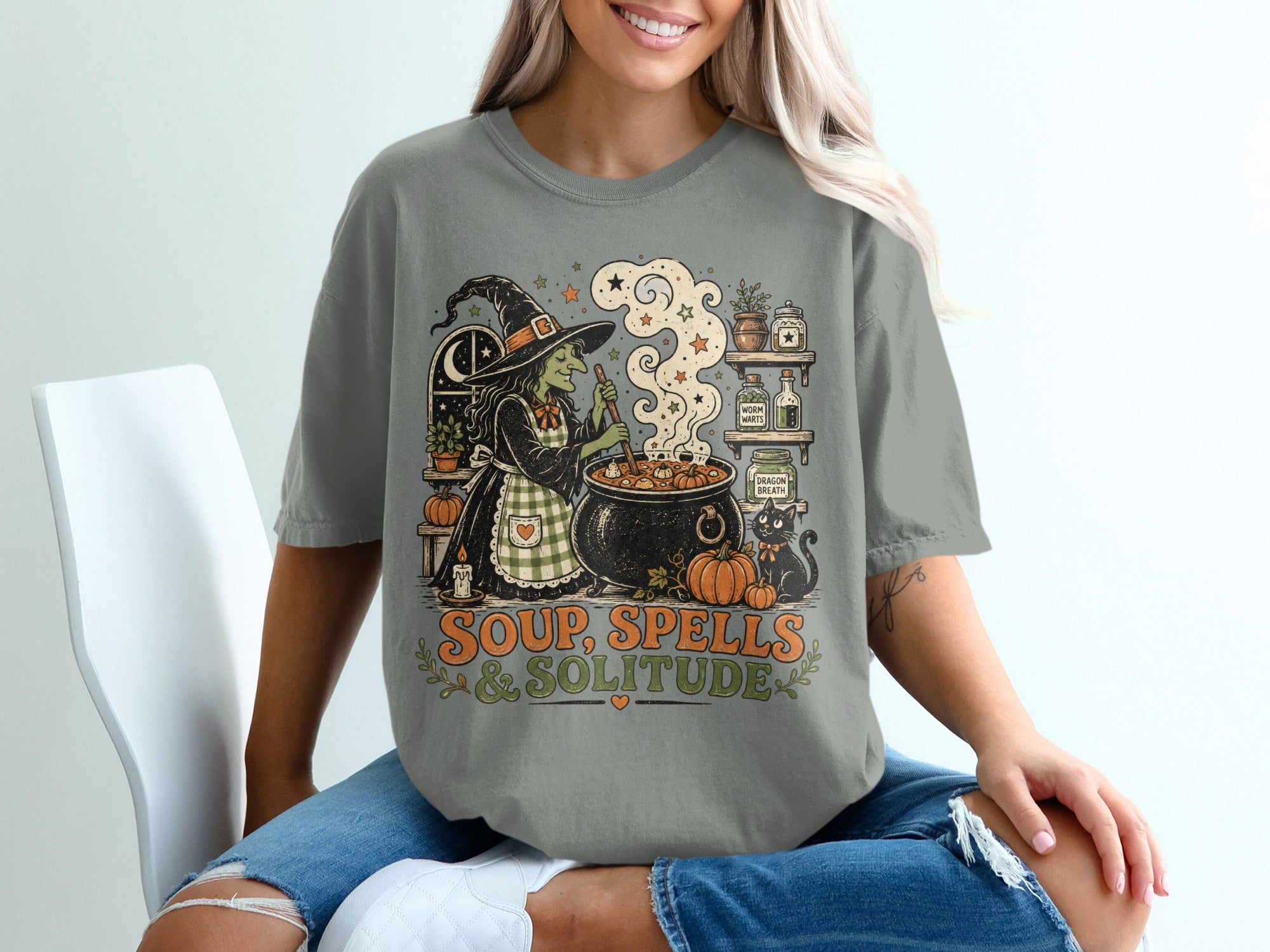 Witch stirring soup with a black cat and text "Soup, Spells & Solitude".